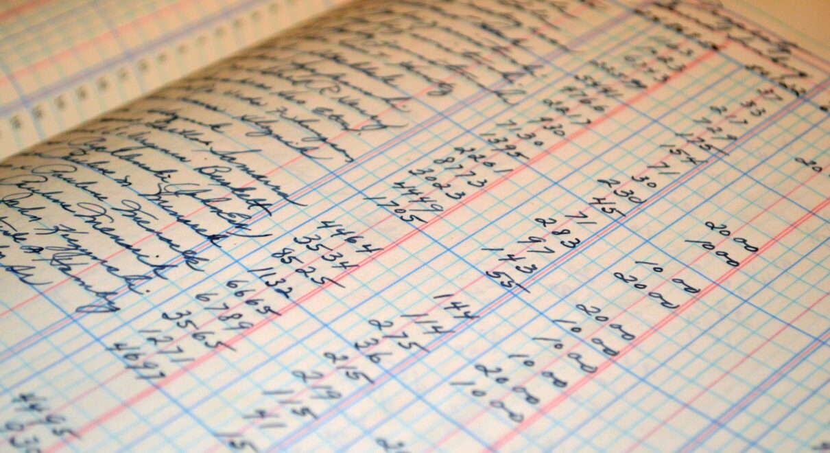 Close-up of a vintage handwritten ledger detailing financial records and accounts.