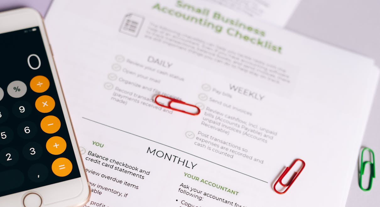 Image of a checklist and calculator for managing small business accounting tasks efficiently.